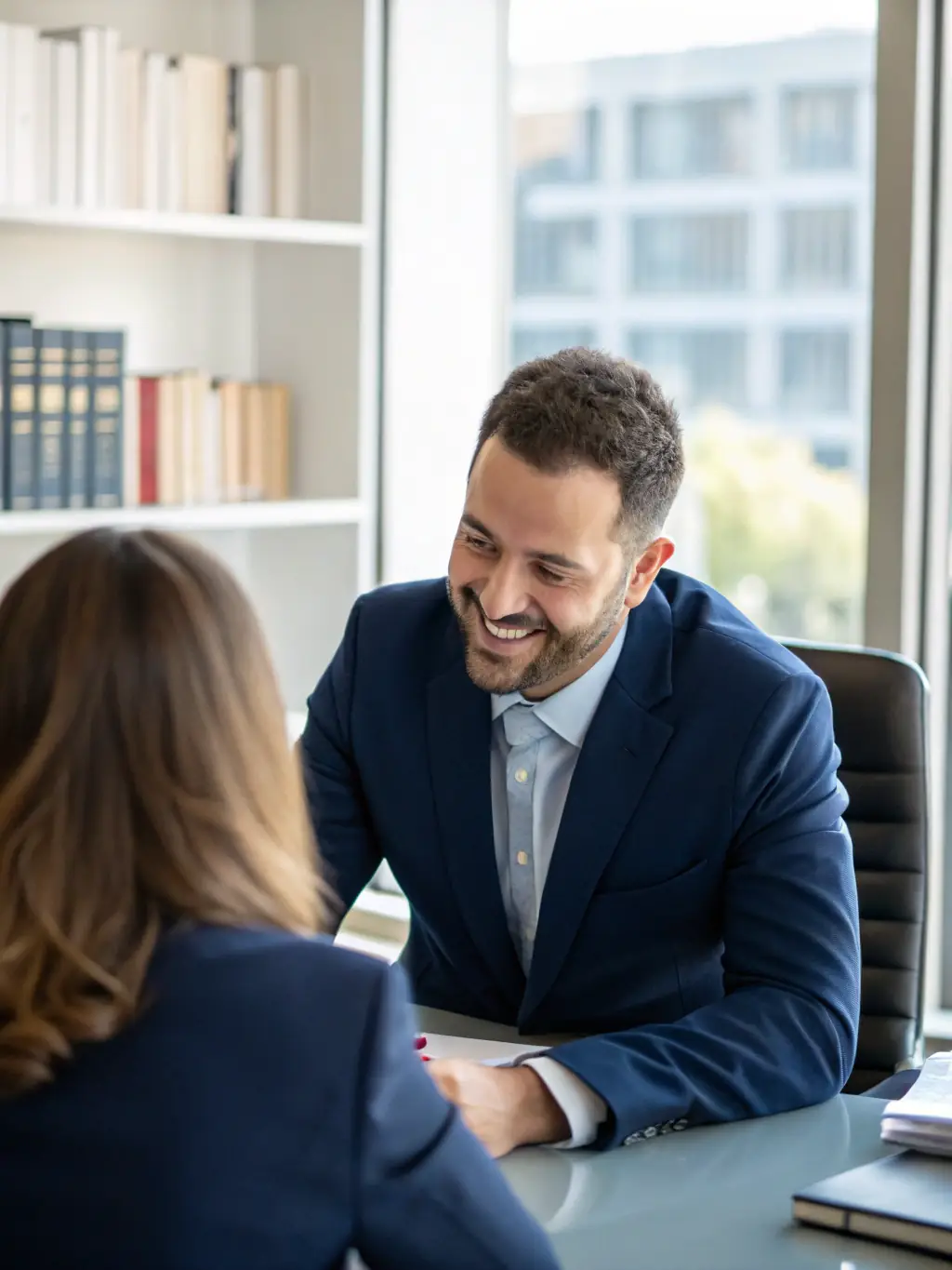A friendly lawyer shaking hands with a new client in a modern office setting, symbolizing the initial consultation at EnterLaw Services.